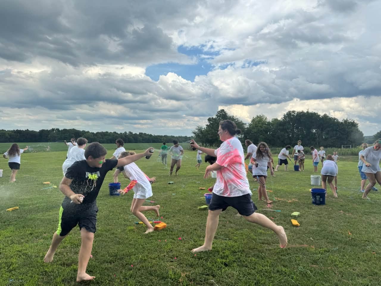Campers playing frisbee in an open field